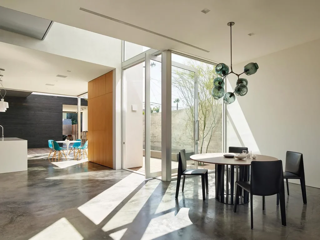 Modern architecture house featuring a clean minimalist exterior, large glass windows, flat roof design, and natural lighting with contemporary materials.